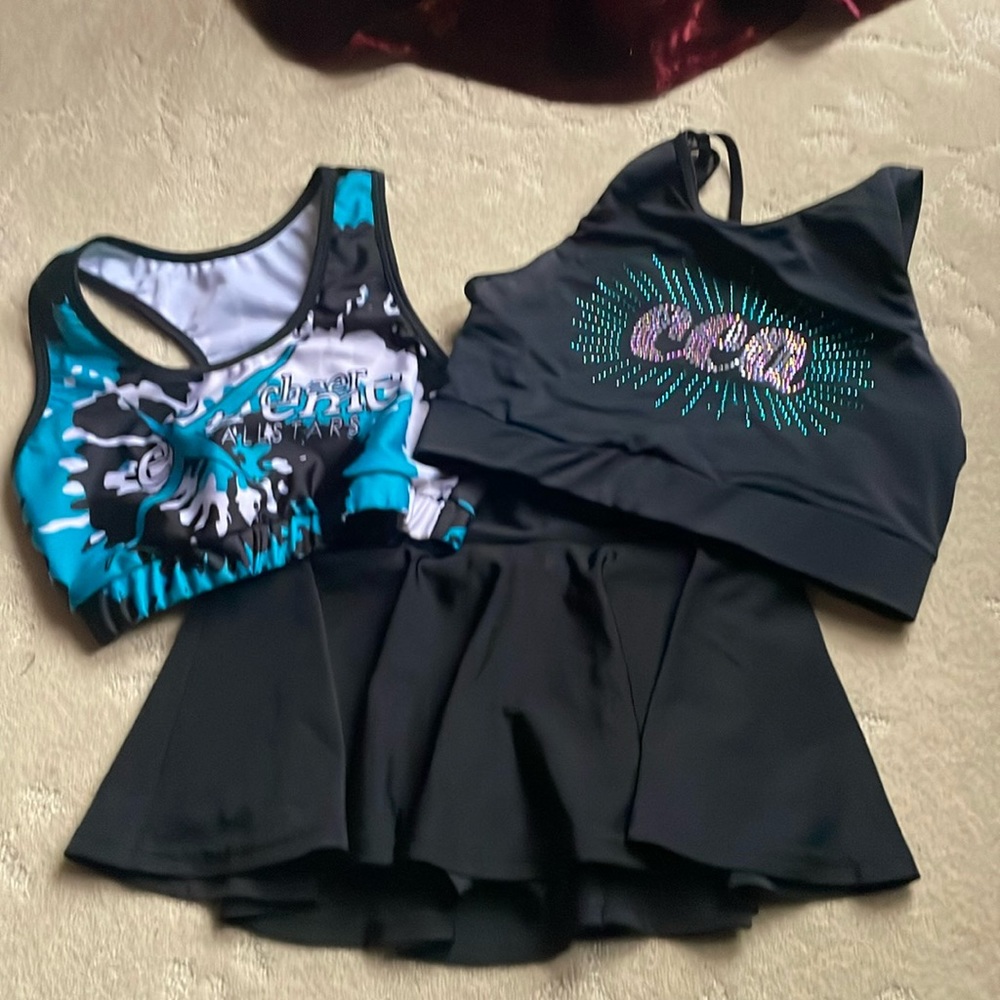 Two Adult small CEA sports bras and one Varsity YL skirt